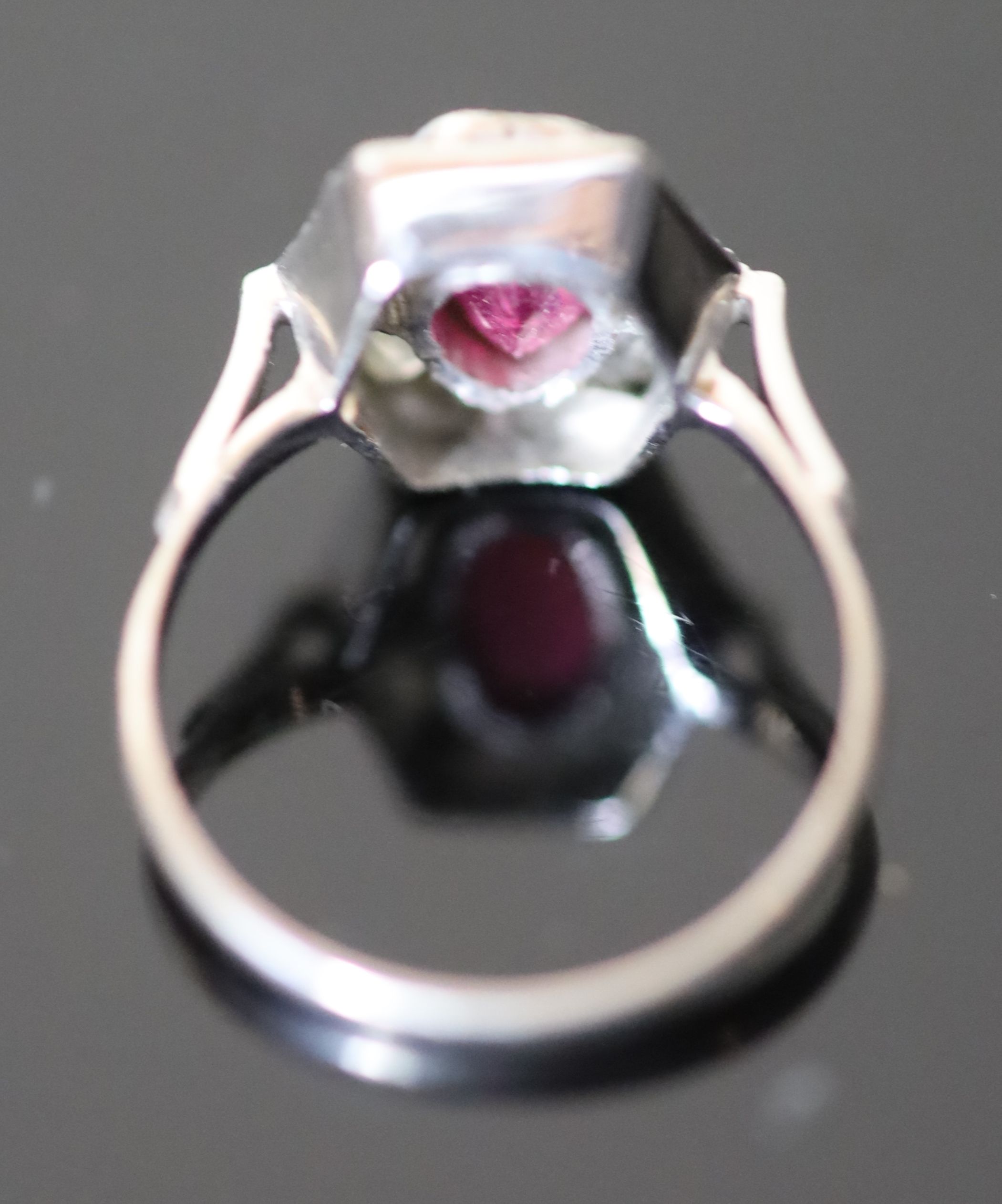 A modern platinum, pinkish/red tourmaline and six stone baguette cut diamond set hexagonal cluster ring,